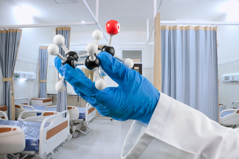 A healthcare professional holding a molecular model in a hospital setting, representing the use of industrial 3D animation to enhance medical training by providing detailed and interactive visual learning tools.